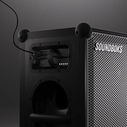 USB-C cable inserted in The Battery while playing on Metallic grey Soundboks 4